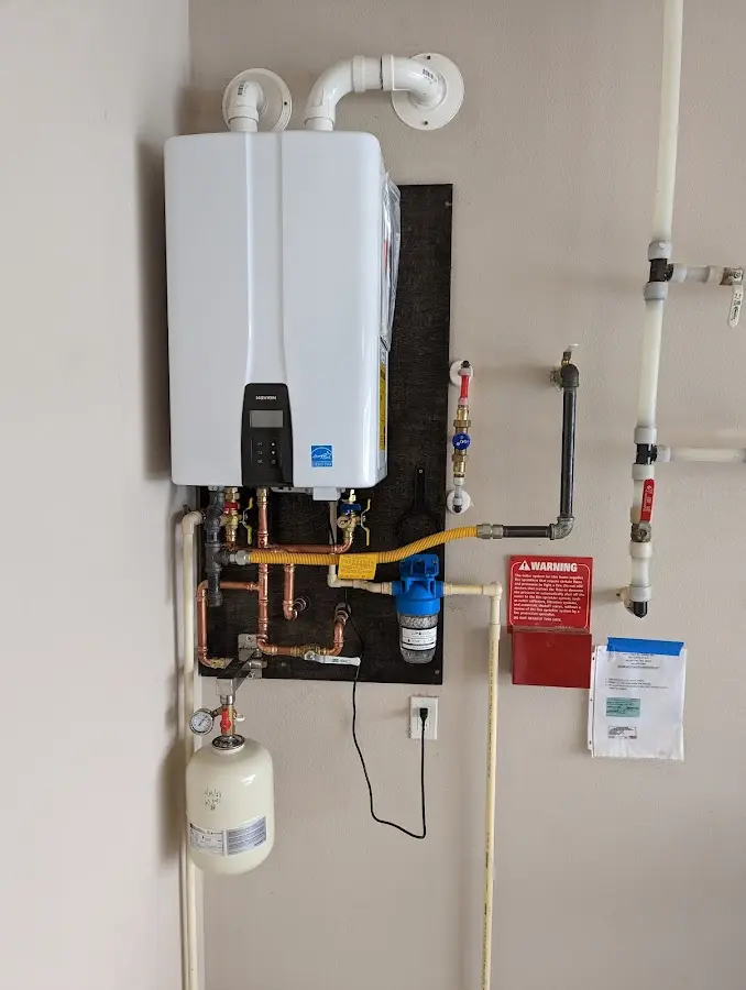 Professional plumber installing copper piping in a Morristown home